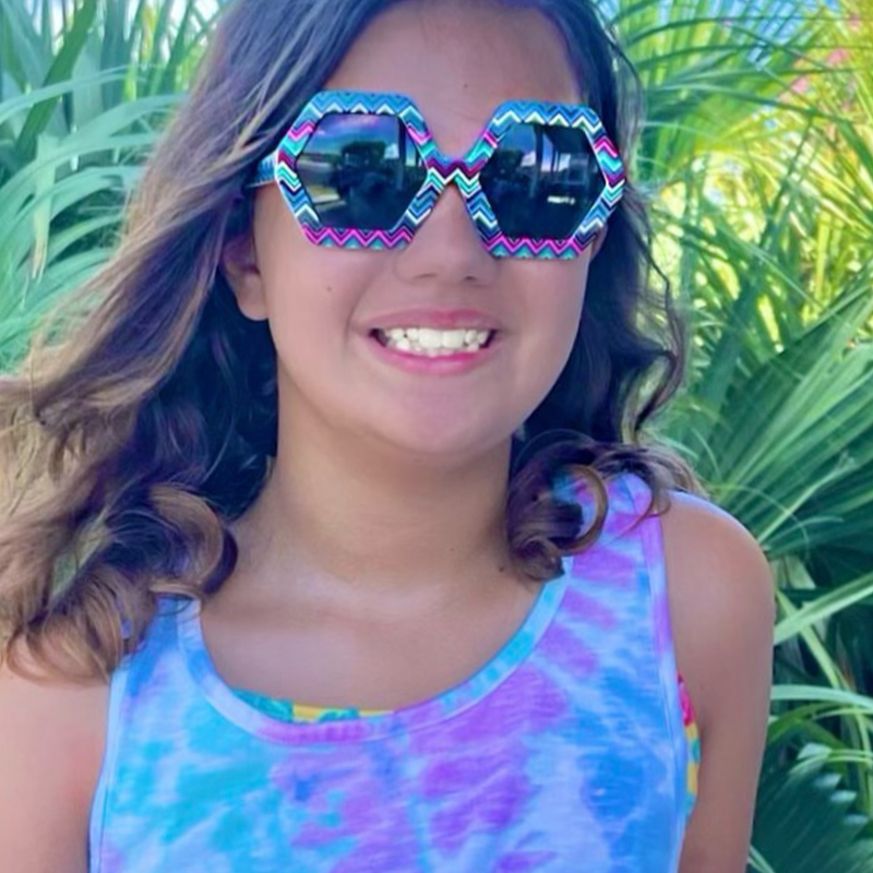 Young girl wearing Just A Shade Smaller Deco sunglasses in chevron pattern