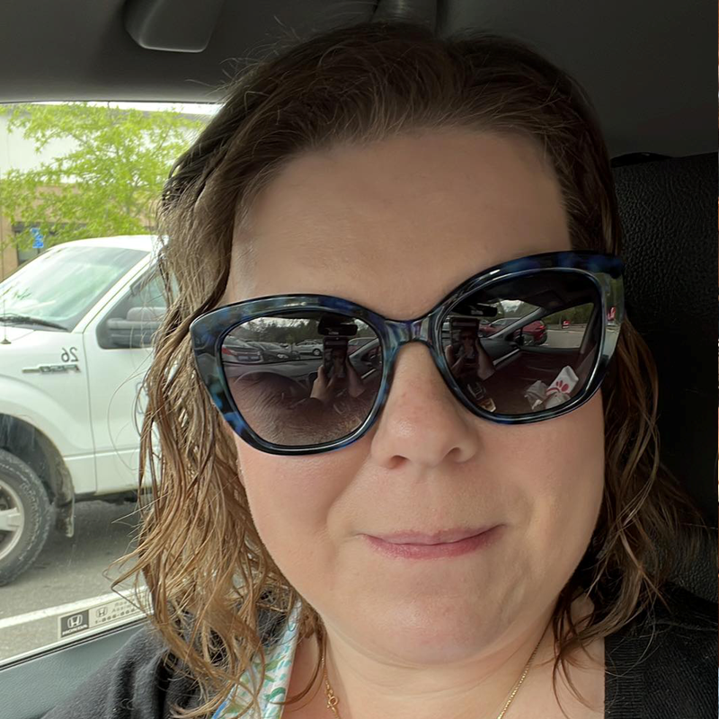 Woman sitting in vehicle wearing Red Carpet Amethyst polarized sunglasses