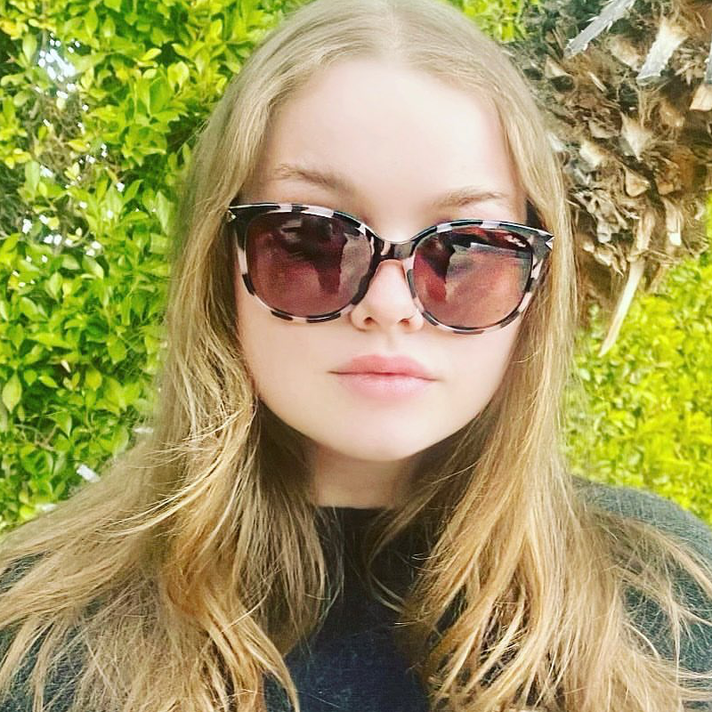 Young woman wearing Red Carpet Sunstone polarized sunglasses