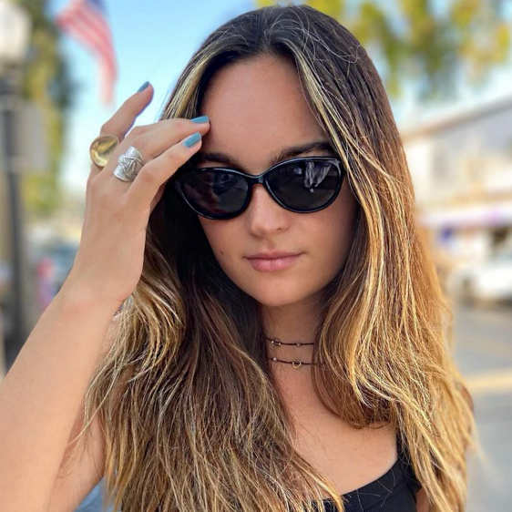 Model wearing Islander Eyes Aruba polarized sunglasses in black frame with grey lenses