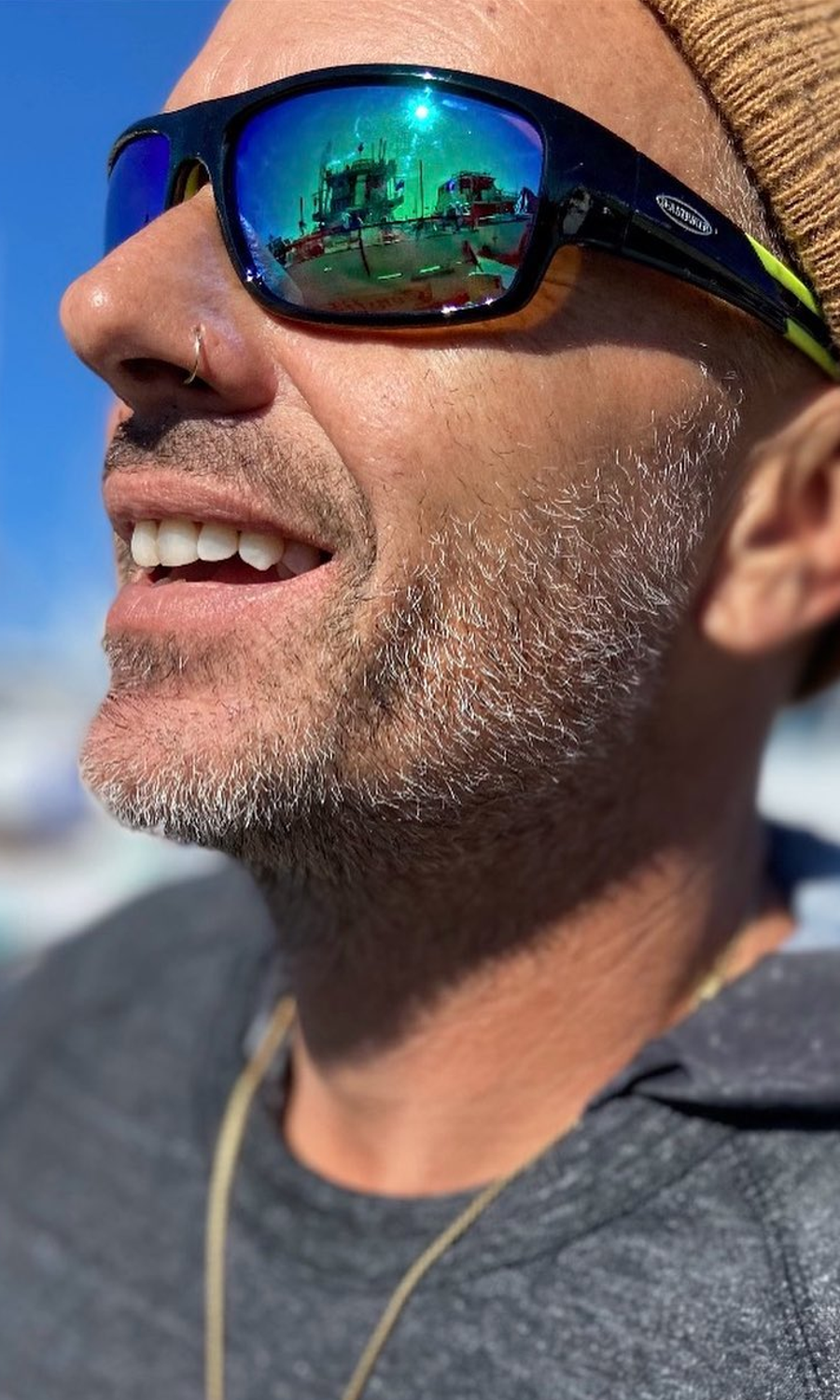 Scruffy man wearing Sea Striker sunglasses.