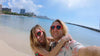 Woman and man wearing red heart shaped sunglasses on beach